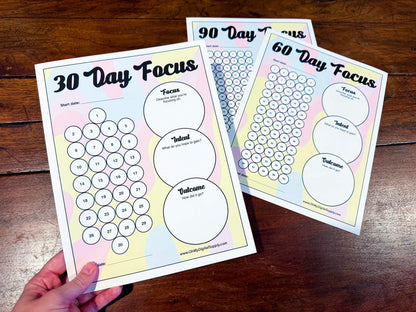 A 30, 60, and 90 Day Focus Worksheet for tracking daily goals, challenges, habits, and more. Each sheet has a space for writing down your focus, intent, and outcome. There are circles you can fill in or cross off each day to indicate you completed your daily focus goal.